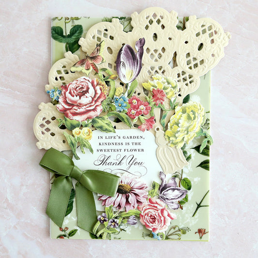 a card with flowers and lace on it.