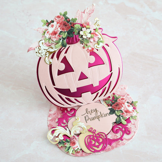 A pop up card with a jack o lantern and flowers.