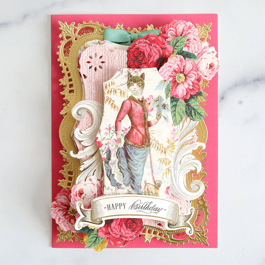 Pink birthday card with gold, pink and floral layers and a cat rub on.