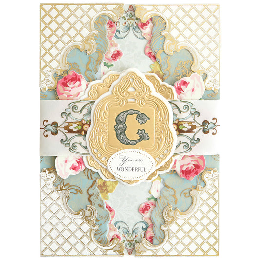 White, blue and pink card with a "c" monogram.