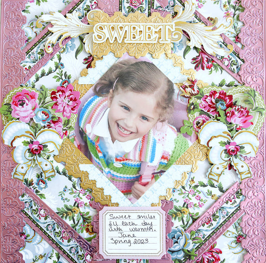 pink embossed scrapbook page with phoebe designs, sweet and a photo of a little girl.