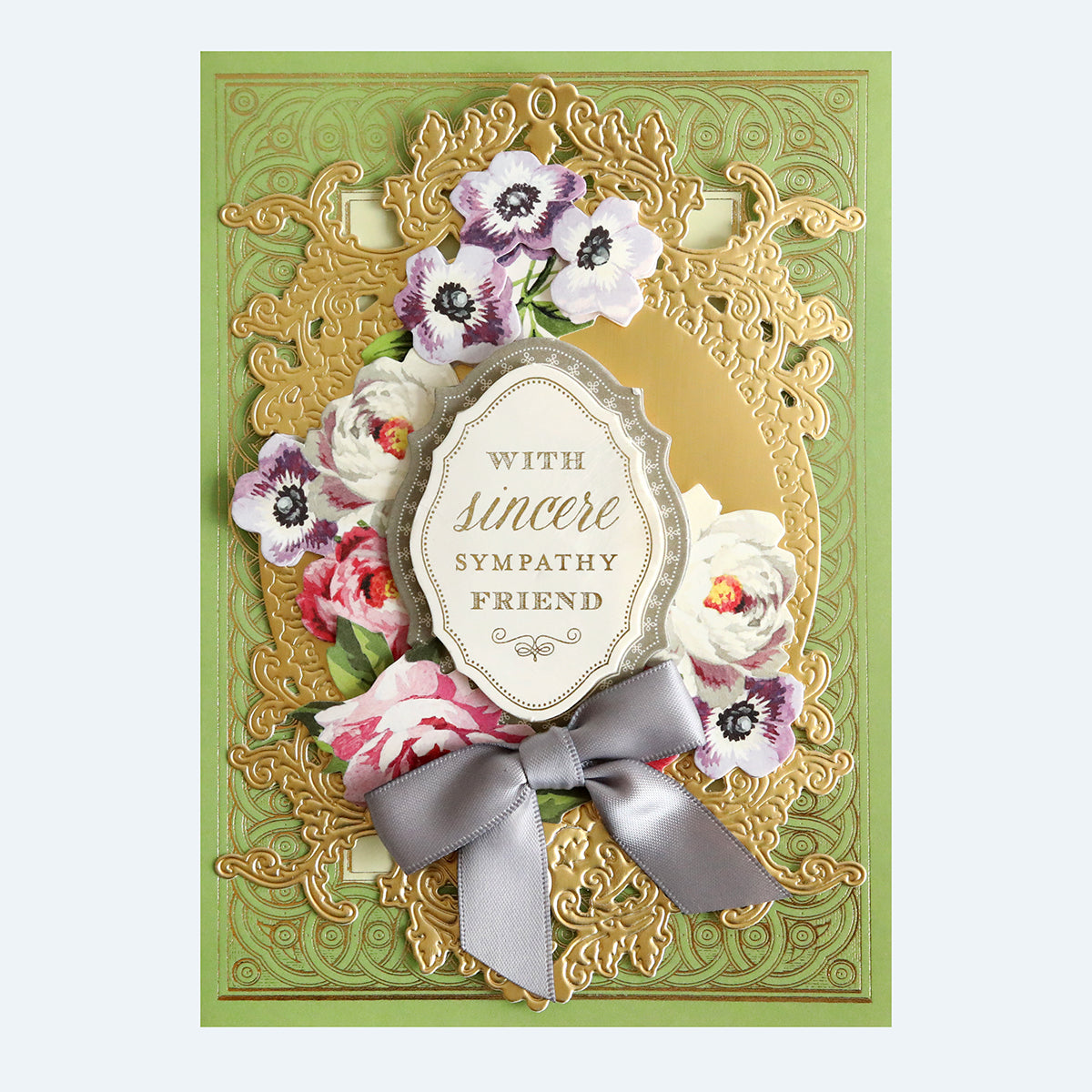 A sympathy greeting card with floral embellishments and a ribbon, featuring the text "with sincere sympathy friend.