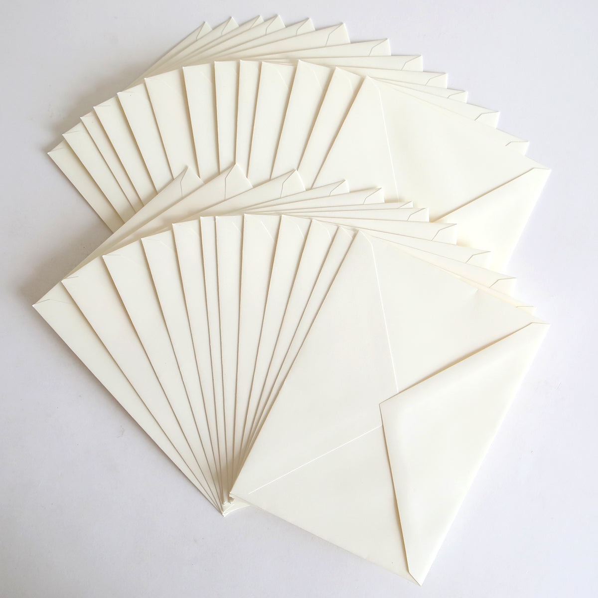 A set of 25 Natural Envelopes (5.25" x 7.25") is fanned out on a plain white surface.