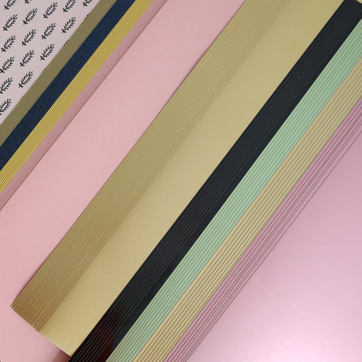 The Crop at Home 3 Swag features a vibrant medley of colored and patterned sheets, ideal for scrapbooking. It includes pink, gold, mint green, striped black, and white with black leaf designs—perfect for your cardmaking or die-cutting projects.