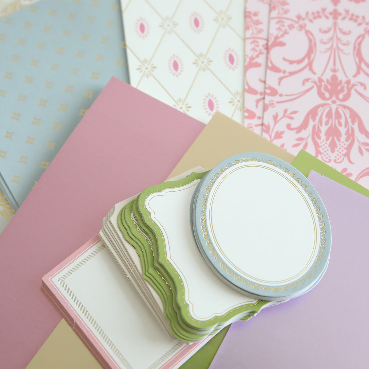 Crop at Home 4 Swag includes assorted patterned and solid die-cutting papers plus stacks of decorative blank labels in various shapes and colors—ideal for scrapbooking or cardmaking.