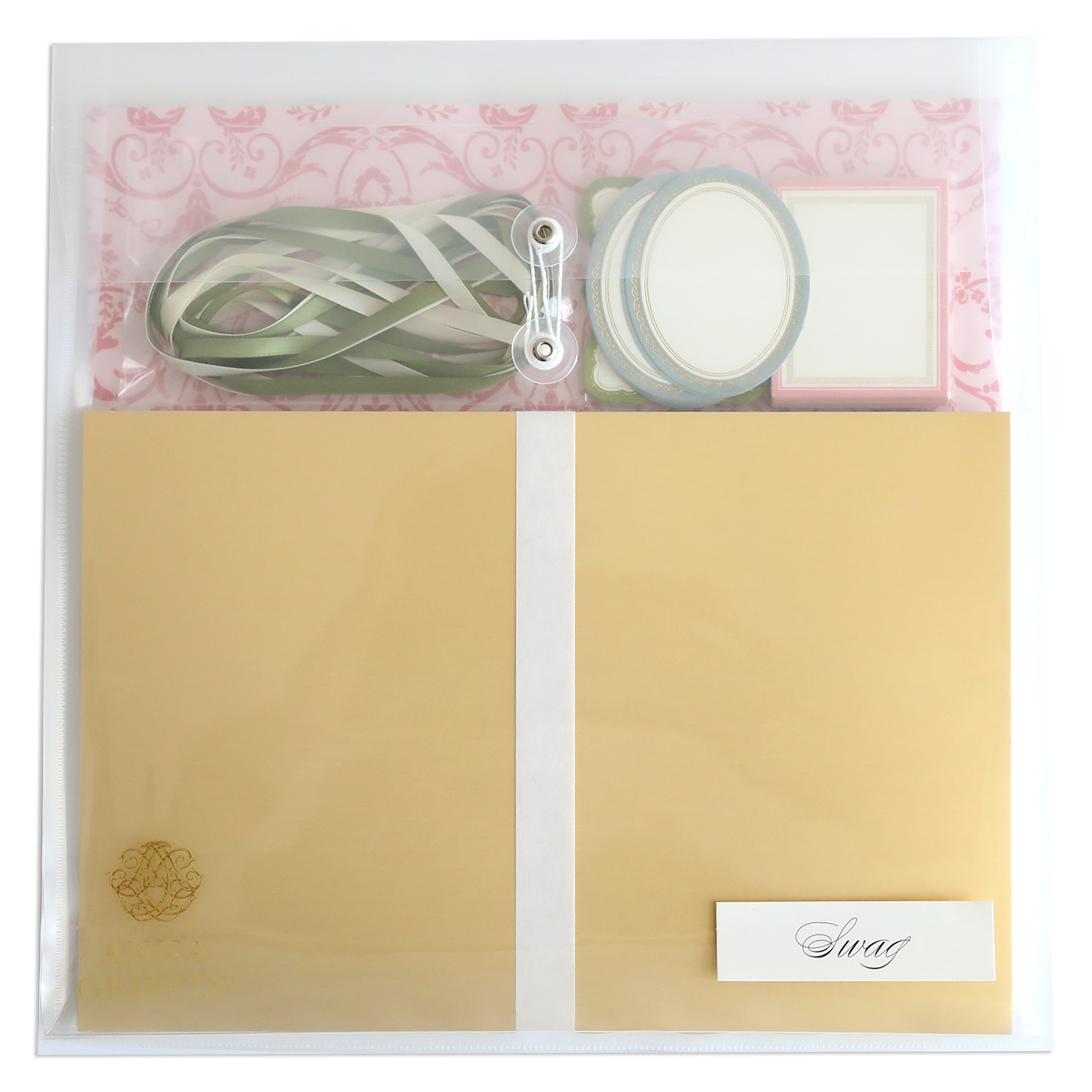 The Crop at Home 4 Swag includes a clear plastic envelope with gold paper, green ribbon, round and square labels, and a "Swag" card—ideal scrapbooking supplies for any creative project.
