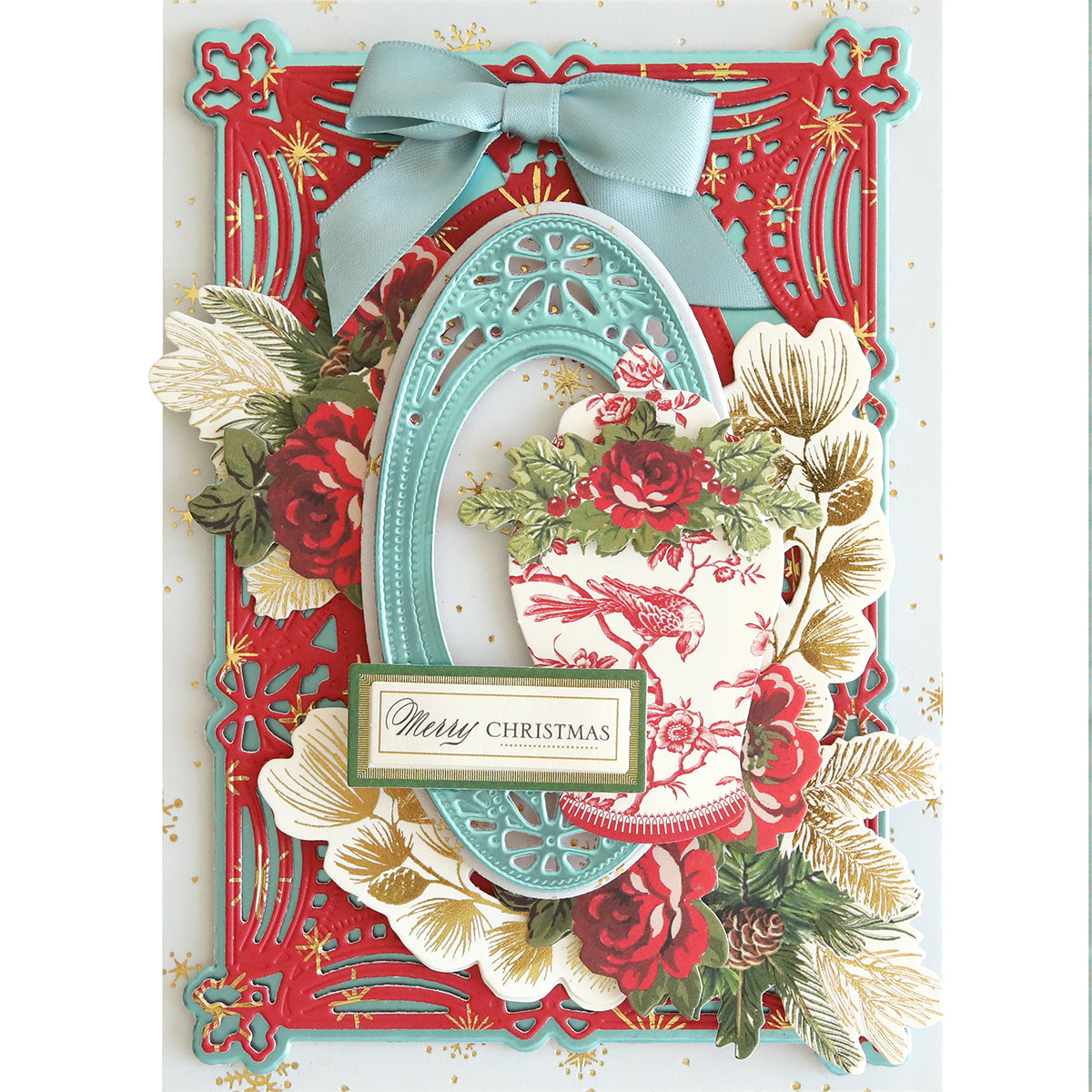 A detailed Christmas card featuring a red frame, blue bow, floral designs, and the words "Merry Christmas" on a rectangular label crafted with festive Christmas Double Sided 300gsm Cardstock.
