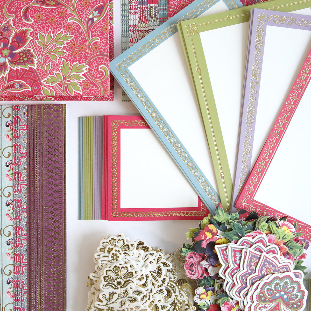 The Simply Paisley Mini Album and Materials features decorative stationery like patterned envelopes, pastel bordered cards, intricate cutouts, and floral embellishments—perfect accents for your next mini album or scrapbook kit.