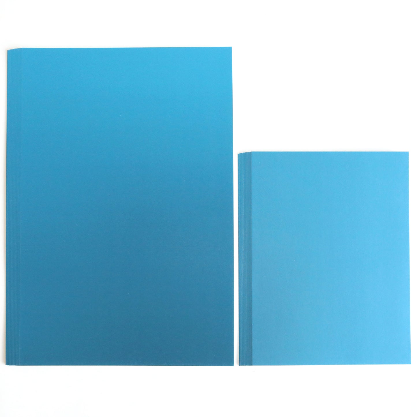 Two Luxury Matte Foil Cardstock Dark Blue books of different sizes with matte foil covers are placed side by side on a white background.