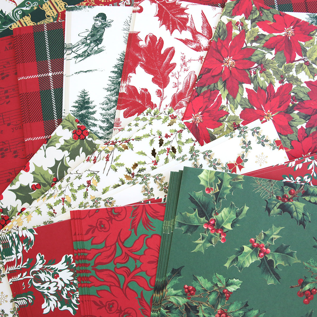 Introducing the Christmas Paper Anthology: a festive collection of wrapping papers showcasing Christmas-themed designs with poinsettias, holly, and plaid patterns. Paired with handmade holiday tags, these winter scenes in red, green, and white beautifully capture the spirit of the season.