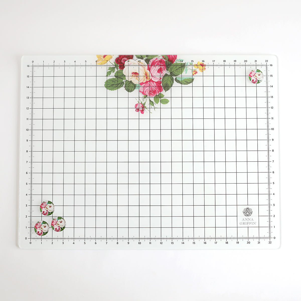 The Glass Magnetic Craft Mat 18 x 24 features centimeter and inch markings plus elegant floral patterns at the top center and corners—ideal for craft lovers. Pair with decorative magnets or use as a stylish magnetic workspace.