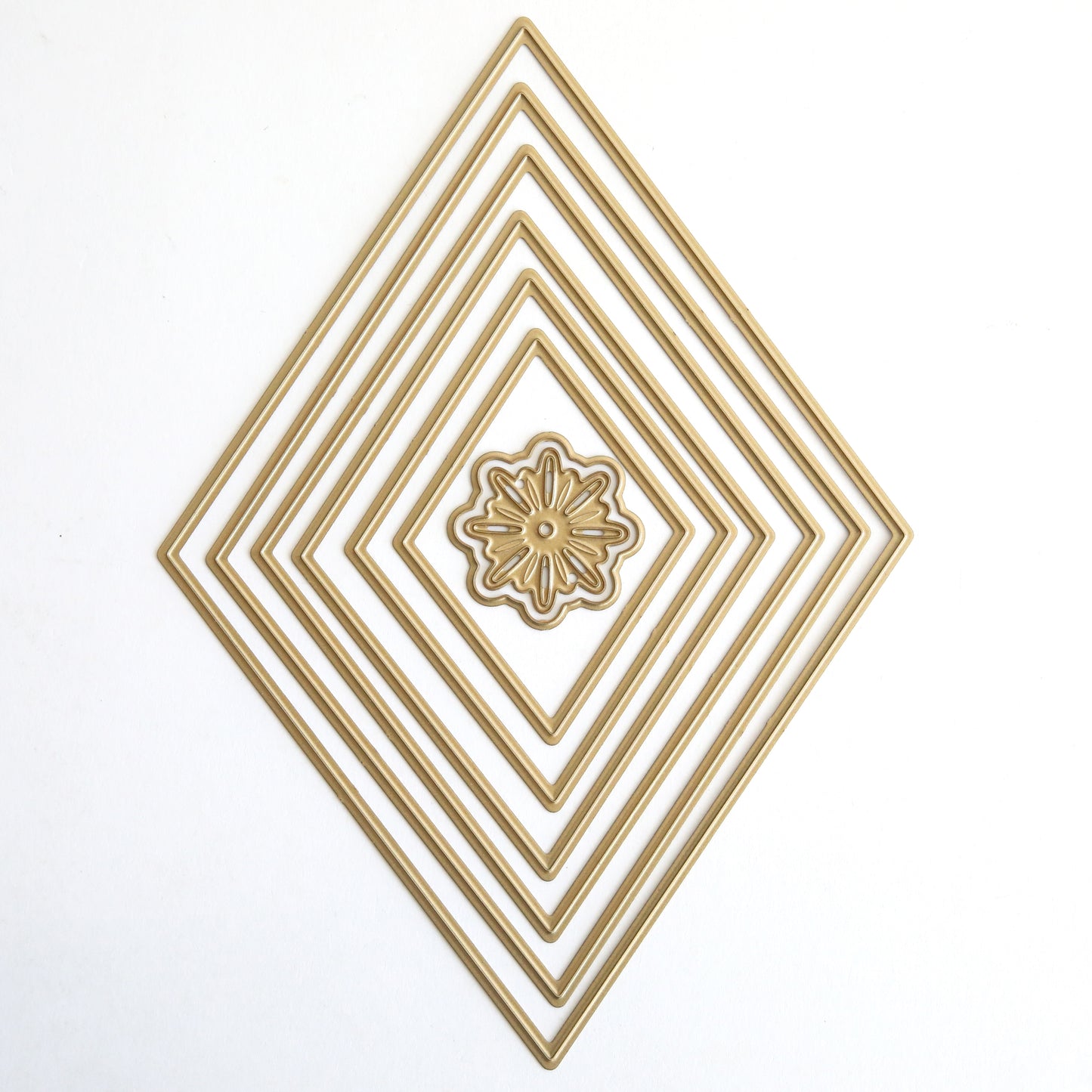 The Crop at Home 5 Concentric Shape Dies feature five diamond-shaped metal frames with a central floral pattern, displayed together on a white background.