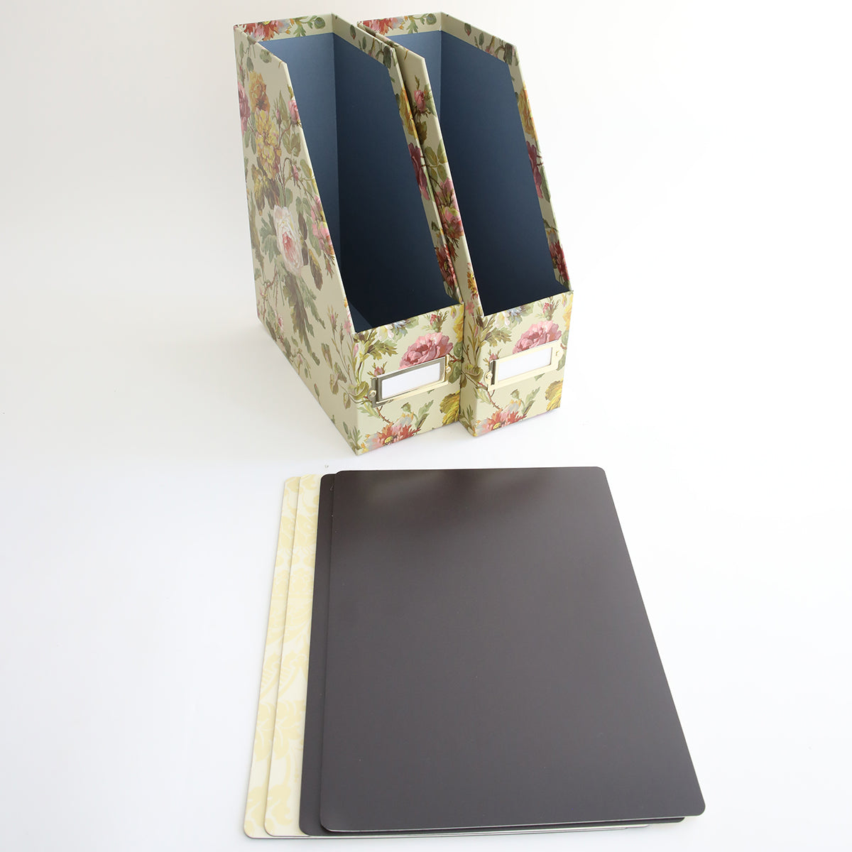 A stylish arrangement of the Set of Large Die Storage Boxes - Francesca includes two floral-patterned magazine holders with front labels and three flat, rectangular dividers, perfect for organizing.