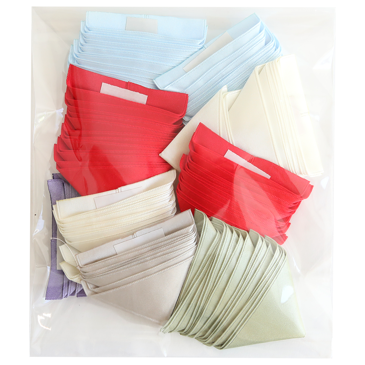 The "Satin Ribbon Corners" set includes a clear plastic bag with folded cloth face masks in red, light blue, white, light green, and lavender, each featuring satin ribbon corners for added comfort and style.
