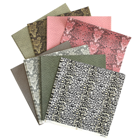 An assortment of textured Animal Print 12x12 cardstock with various designs for papercraft projects.