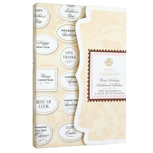 A gift box adorned with an assortment of Holiday Mini Sentiment Stickers and layered greetings.