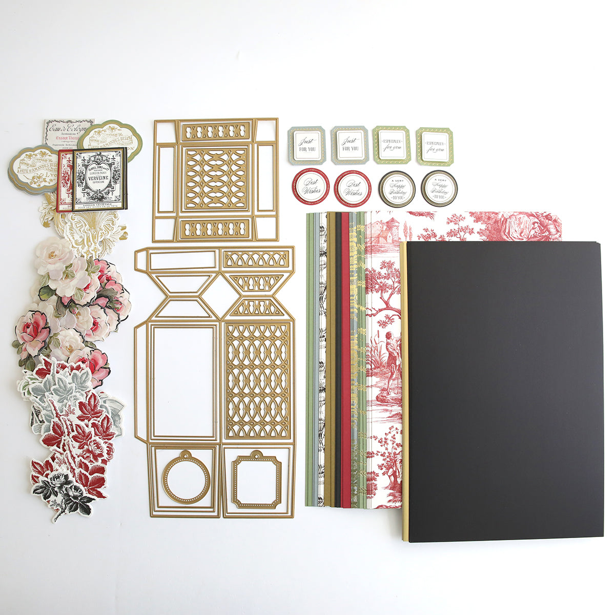 A Perfume Box Class Materials and Dies containing a collection of scrapbooking supplies, including a book and a notebook.