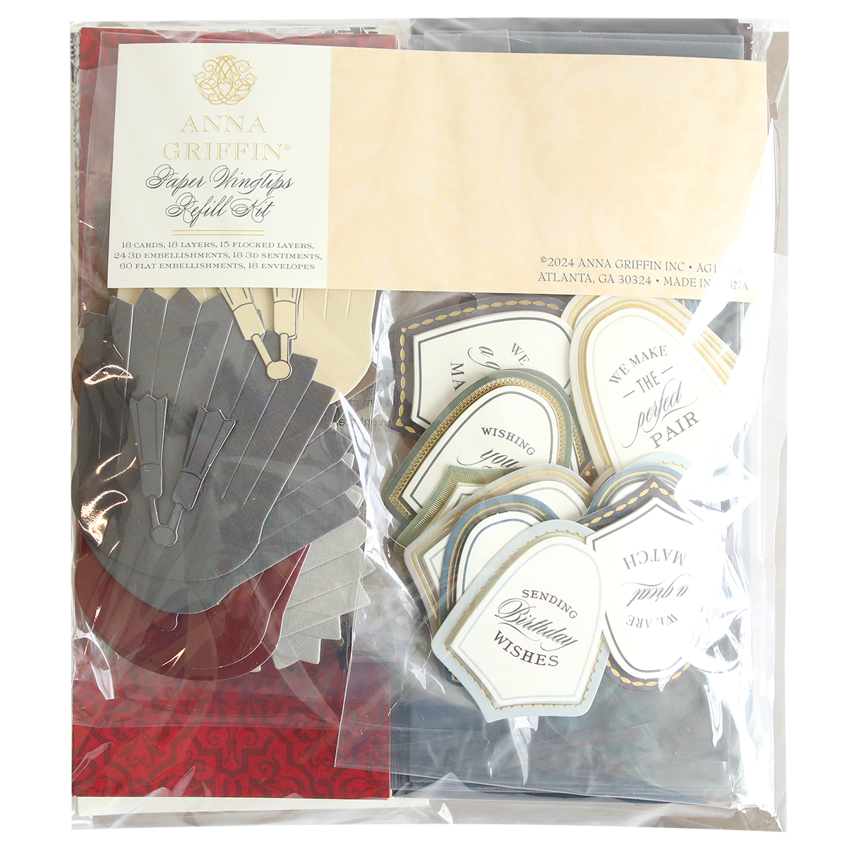 A packaged set of Paper Wingtips Refill Kit, including various folded leaf designs in grey and red, and labeled tags with phrases like "We make the perfect pair" and "Sending wishes," enhanced with 3D embellishments for an added touch of elegance.