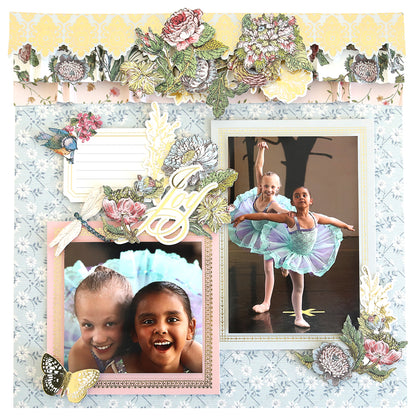 A scrapbook album page featuring two framed photos of young girls in ballet outfits, decorated with floral and butterfly motifs from the Simply Wildflower Meadow Scrapbook Kit, and a "joy" embellishment.