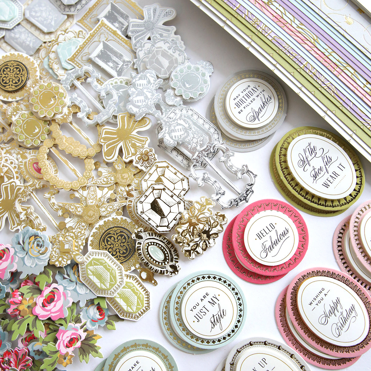 A variety of Paper Shoes Finishing School Refill Kit cardstock and embellishments are laid out on a table.