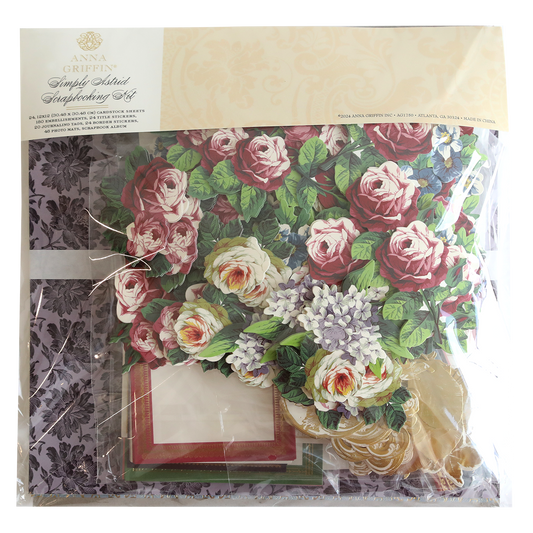 The Simply Astrid Scrapbooking Kit with Album features Anna Griffin’s floral designs, frames, and patterned paper in rich red, white, green, and purple—ideal for card making or scrapbooking projects.
