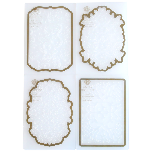 Four ornate die-cut paper frames in different shapes, with decorative embossed patterns from Card Layer Cut & Emboss Folders and brown borders, displayed on a white background.