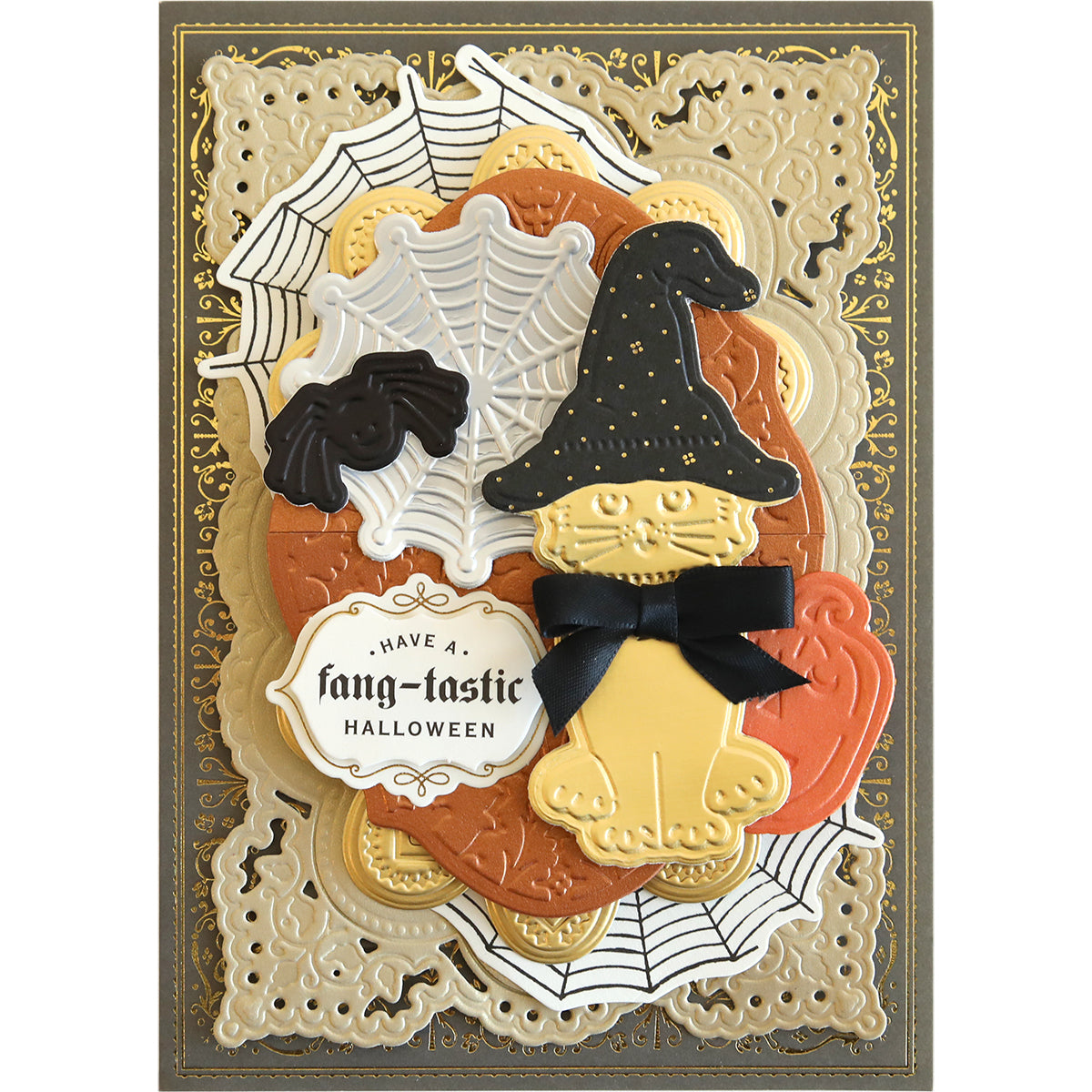 Decorative Halloween card featuring a spooky scene: a cat wearing a witch hat, bats, spider webs, pumpkins, and a message that reads "Have a fang-tastic Halloween," all enhanced with the Spooktacular Friends Cut and Emboss Folders for an extra touch.