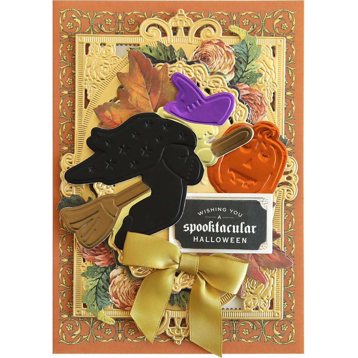 A Halloween card created with the Spooktacular Friends Cut and Emboss Folders showcases intricate floral borders, a gold bow, and festive embellishments featuring a witch, pumpkin, and hat. The text reads "Wishing You a Spooktacular Halloween," perfectly encapsulating the spooky spirit of the season.