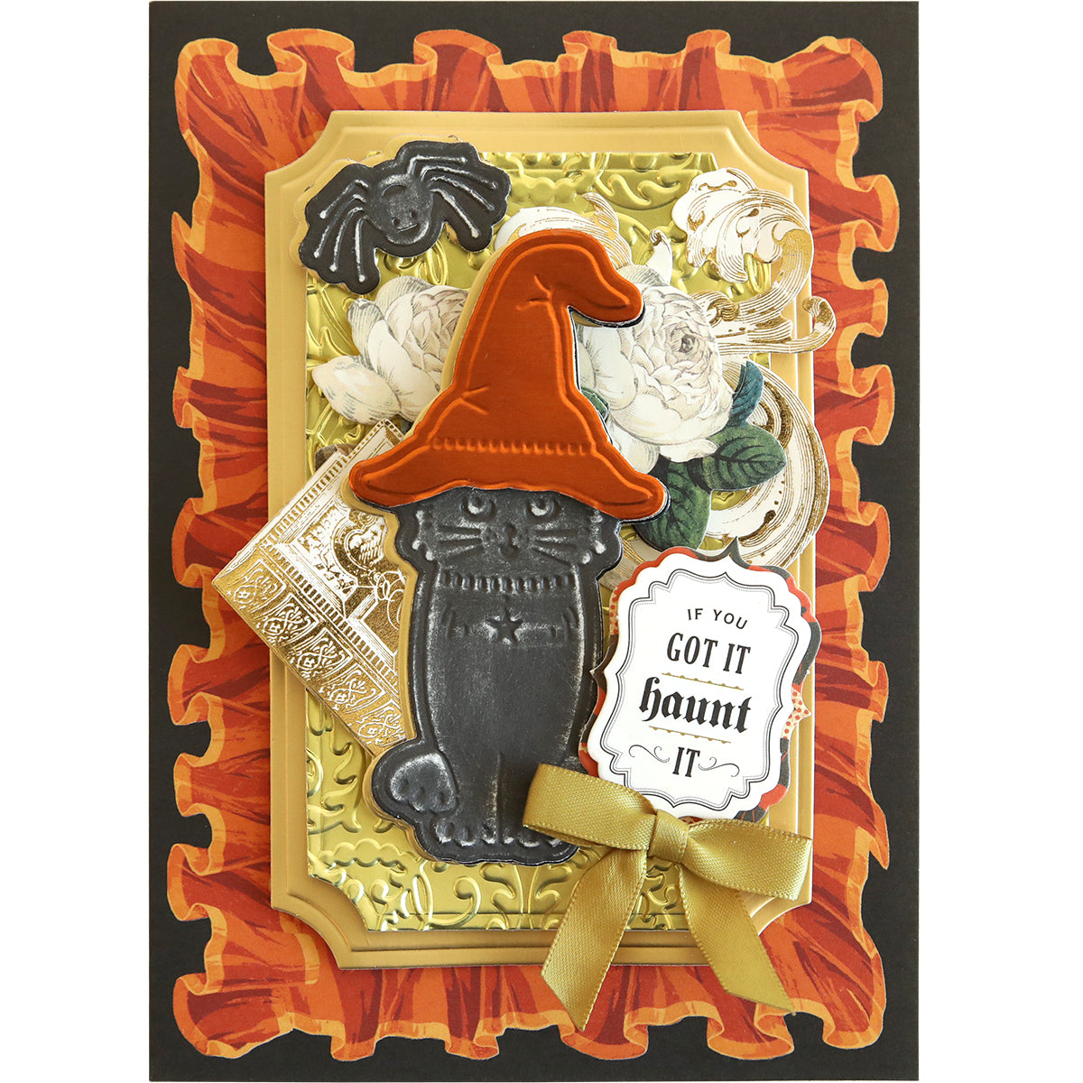 The Spooktacular Friends Cut and Emboss Folders create a Halloween-themed greeting card featuring a black cat with an orange witch hat, a gold bow, and an "If you got it, haunt it" message surrounded by intricate floral patterns and spooky scene embellishments.