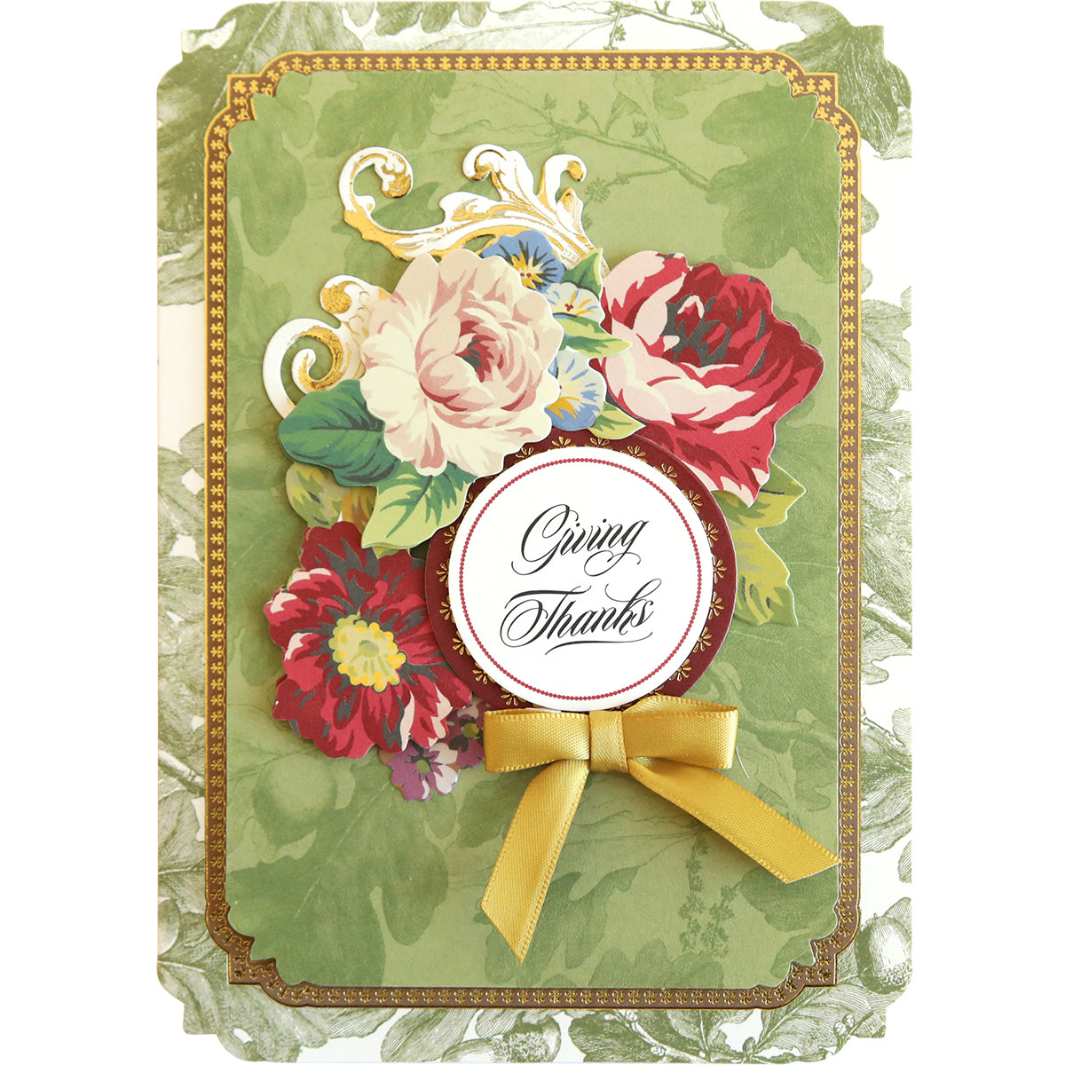 Introducing the Simply Thanksgiving Card Making Kit: Create an elegant greeting card adorned with ornate flowers, a gold ribbon bow, and a circular "Giving Thanks" message in the center. This beautiful design is set against a green background with gold-trimmed edges, perfect for anyone who loves handmade cards or enjoys using crafting supplies to make their own masterpieces.