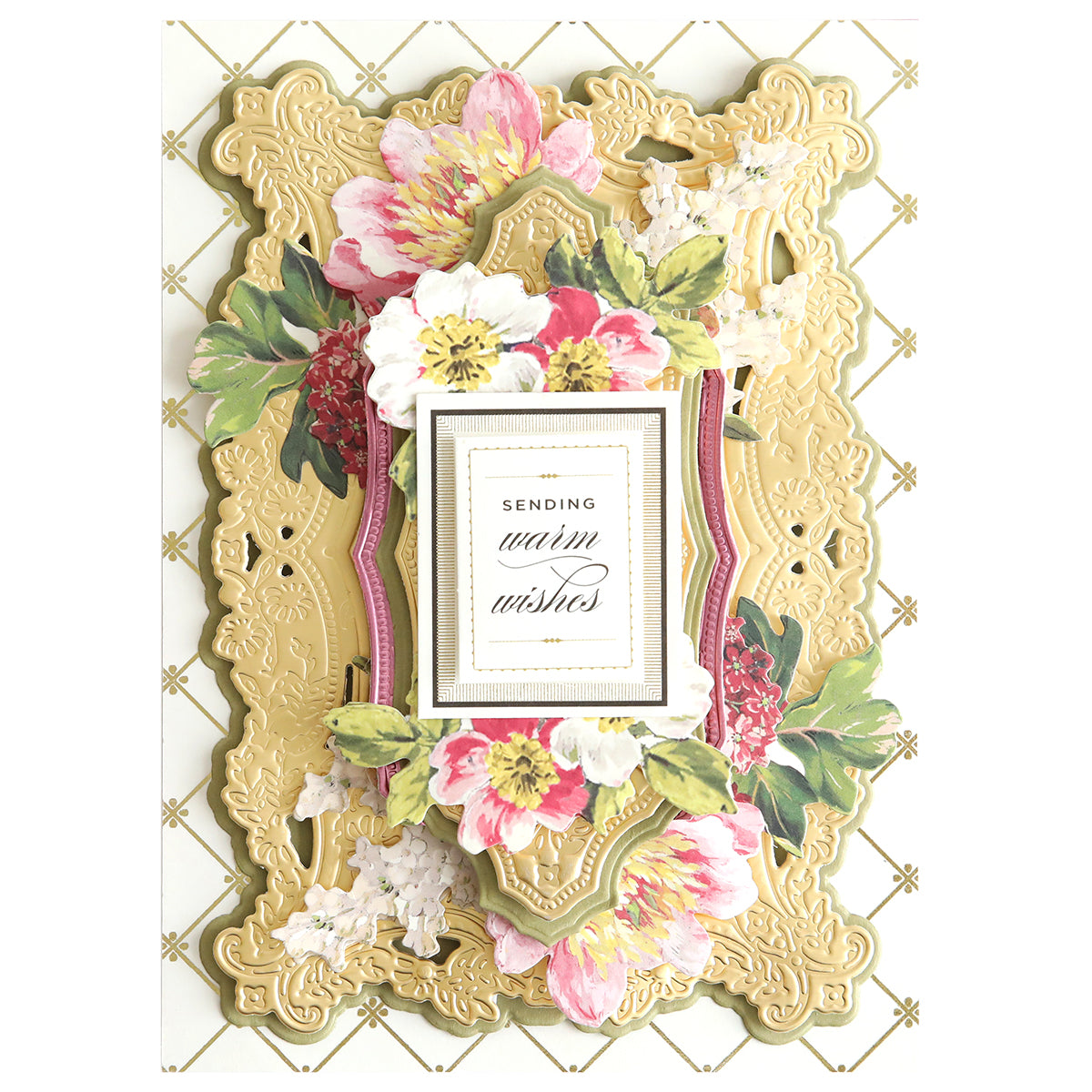 The 3D Filigree Concentric Dies offer an ornate floral greeting card featuring pink and white flowers, intricate gold patterns, and "Sending warm wishes" at the center in a stylish concentric design.