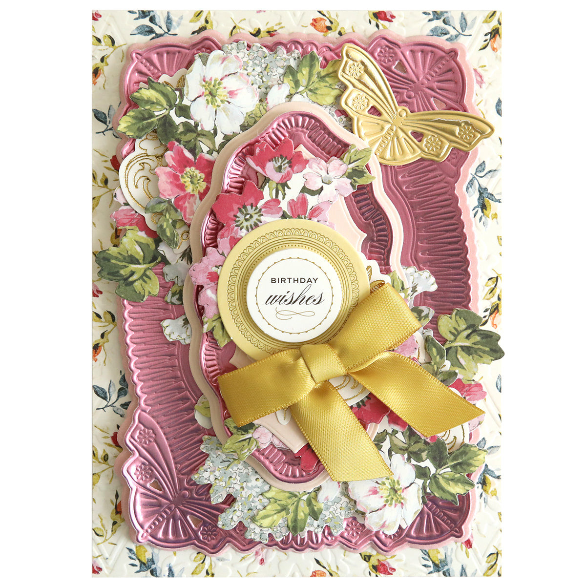 A decorative birthday card made with 3D Butterfly Concentric Dies, showcasing layered floral patterns, gold butterfly accents, a gold ribbon bow, and "Birthday wishes" in the center.