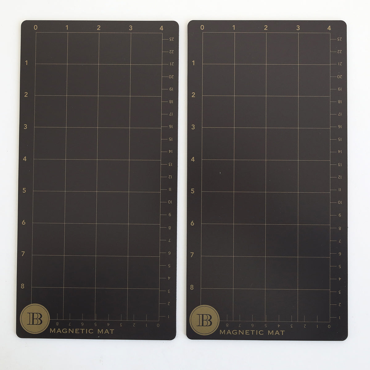 The Empress Elite Mini 5" x 10" Set of 2 Magnet Mats features rectangular black mats with gold grid lines and scales, each labeled "MAGNETIC MAT" with a circular "B" logo—ideal magnetic surfaces for precise die cutting.