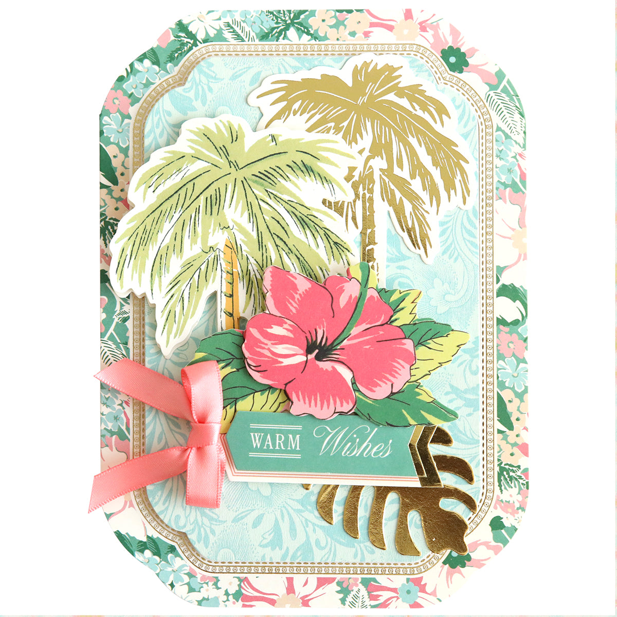 The Simply Tropical Card Making Kit includes a decorative card featuring illustrated palm trees, a pink hibiscus flower, 3D embellishments, and a "Warm Wishes" label on a floral background—ideal for handmade tropical cards.