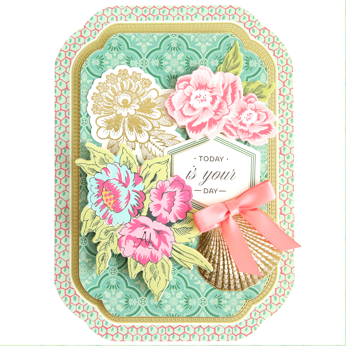 A decorative handmade card from the Simply Tropical Card Making Kit featuring floral designs, 3D embellishments, a pink ribbon bow, and "Today is your day" text on a green and gold patterned background.