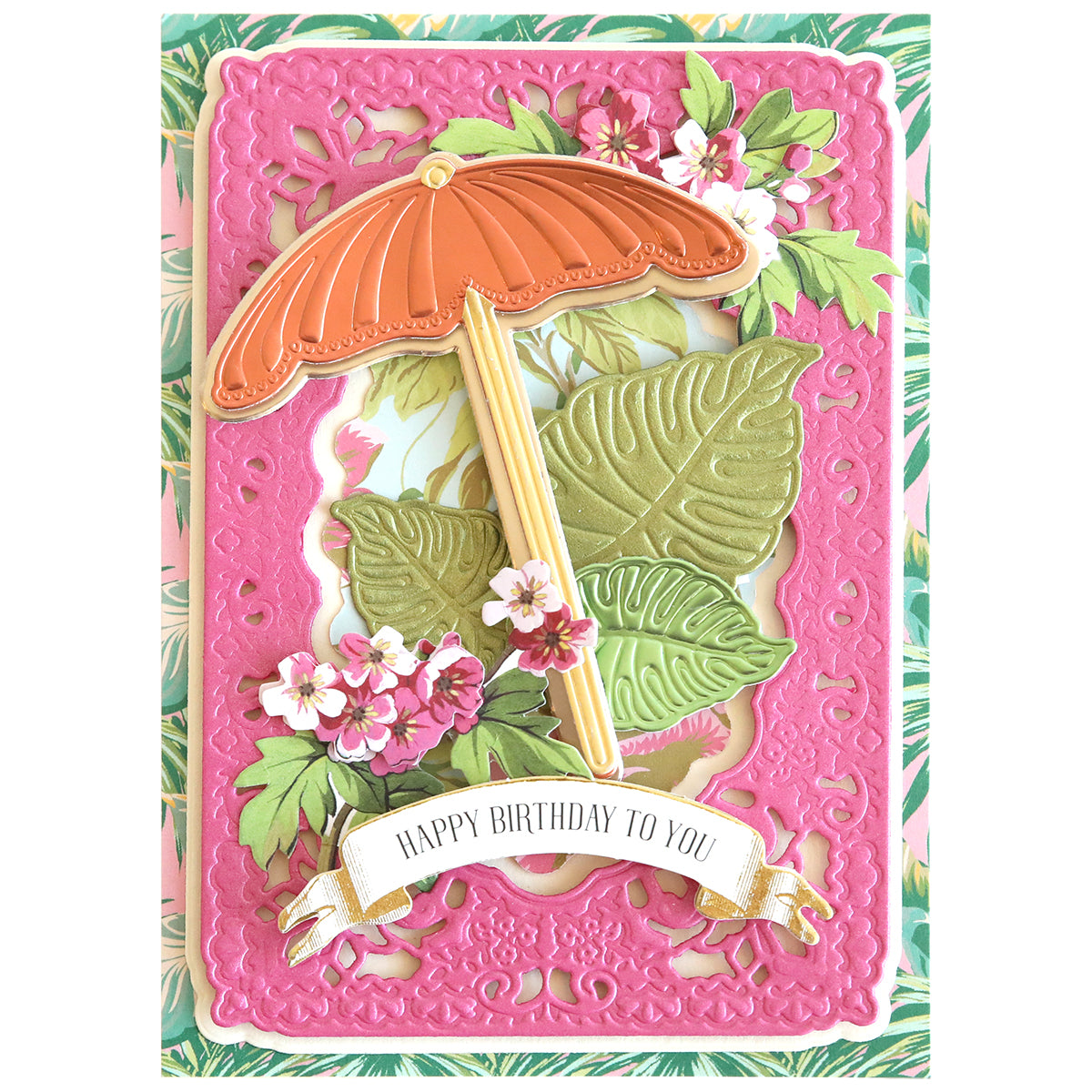 A vibrant birthday card featuring a pink ornate border, tropical leaves, flowers, and an orange umbrella evokes a tropical oasis vibe. The banner reads "Happy Birthday to You!" It's perfect for scrapbooking special moments with the feel of stepping into 3D Paradise Dies.