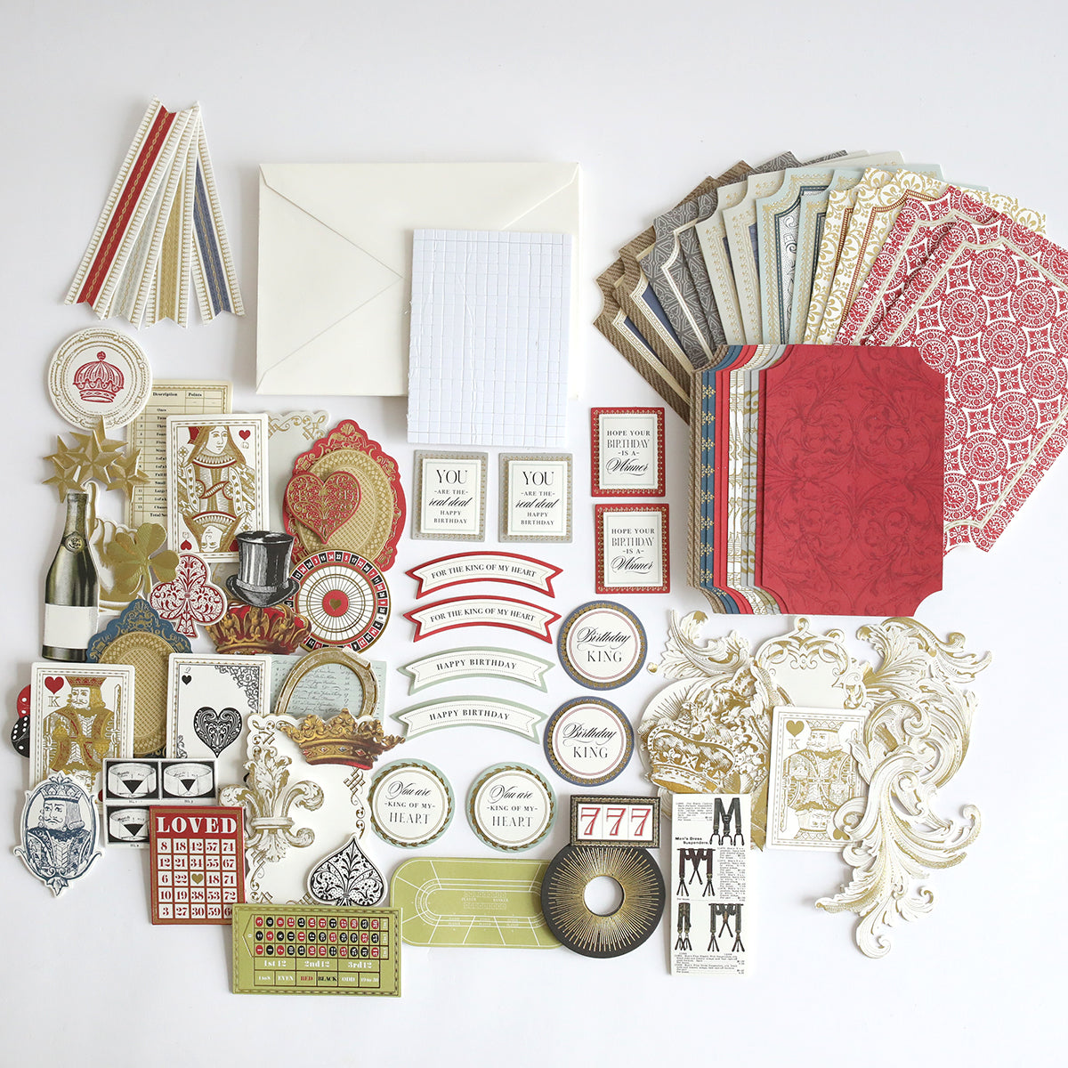 The Simply King of My Heart Card Making Kit includes ornate paper craft materials like envelopes, handmade cards, labels, die-cuts, and 3D embellishments arranged on a white surface.