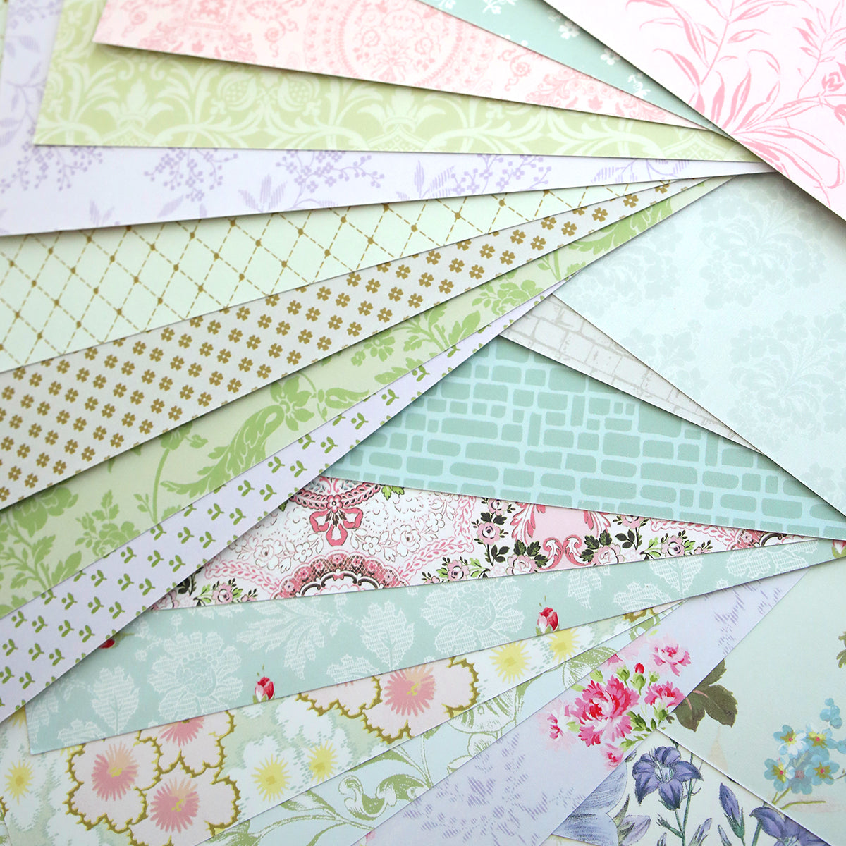Windmill 12x12 Cardstock features double-sided sheets in pastel tones with floral, geometric, brick, and damask patterns.