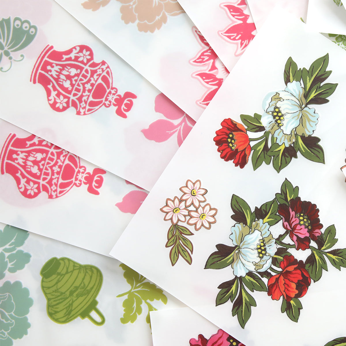 Lian Rub On Transfers feature colorful floral and teapot illustrations in an overlapping pattern, perfect for adding a whimsical touch to scrapbook pages or any creative project.
