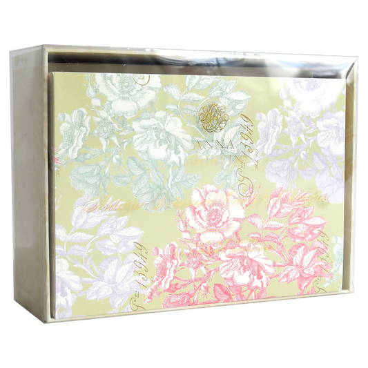 A box of Antique Botanical Cards and Envelopes, wrapped in clear plastic and featuring beautiful pink, white, and purple floral patterns on a pale yellow background inspired by vintage botanical cards.