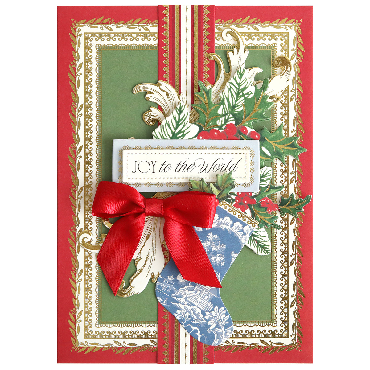 Create festive handmade cards with the Christmas Present Card Making Kit, featuring a decorative holiday card with gold and green borders, a red ribbon bow, blue stocking, holly leaves, and "Joy to the World" text.