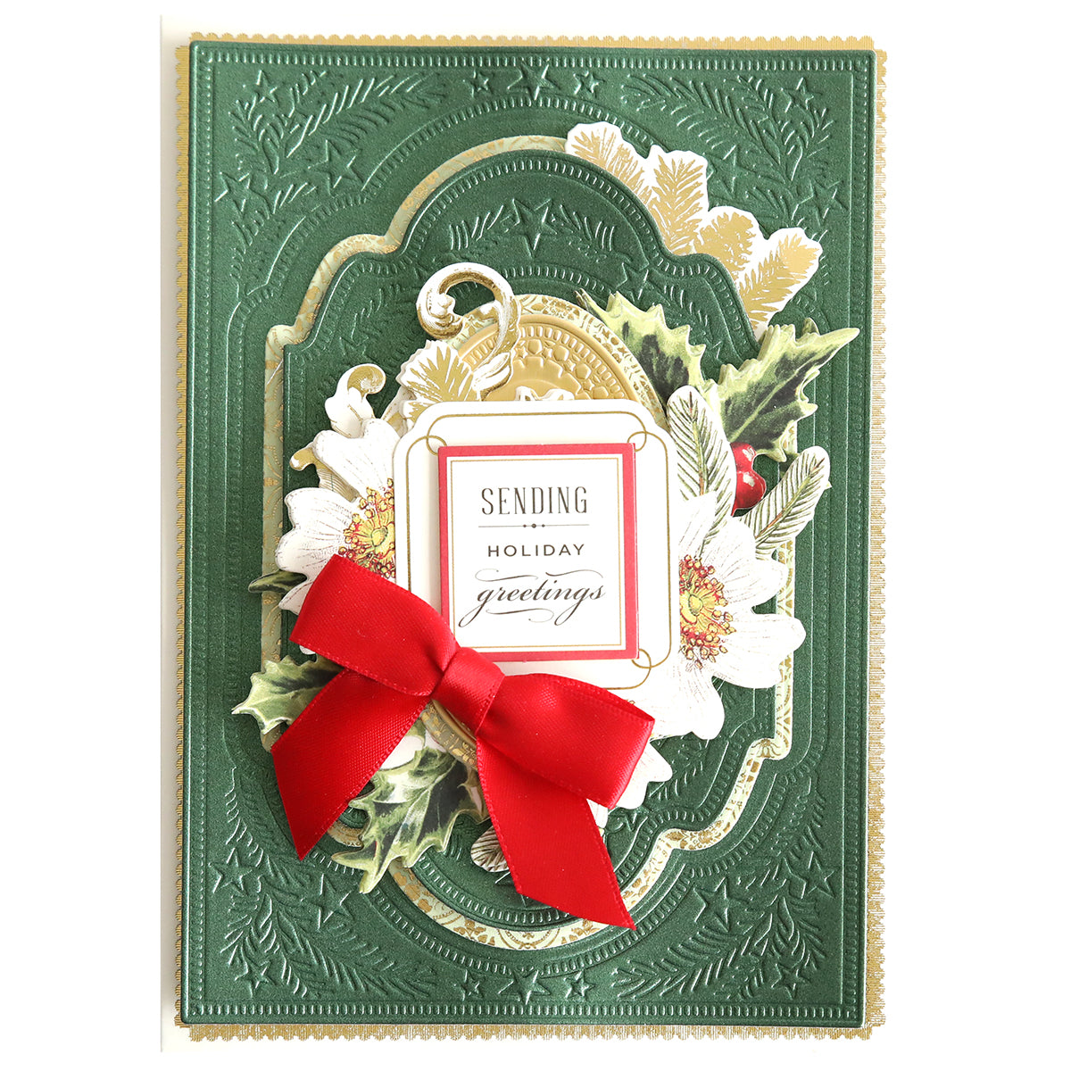 A green embossed holiday card with white flowers, holly, a red bow, and a "Sending Holiday Greetings" label—ideal for festive crafts using Christmas Present 3D Concentric Dies.