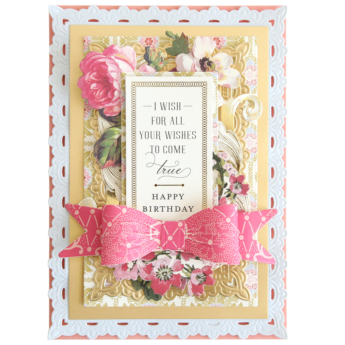 A charming handmade birthday card, crafted using Bow Cut & Emboss Folders, features floral patterns, ornate gold accents, a large pink paper bow, and the message: "I wish for all your wishes to come true. Happy Birthday.