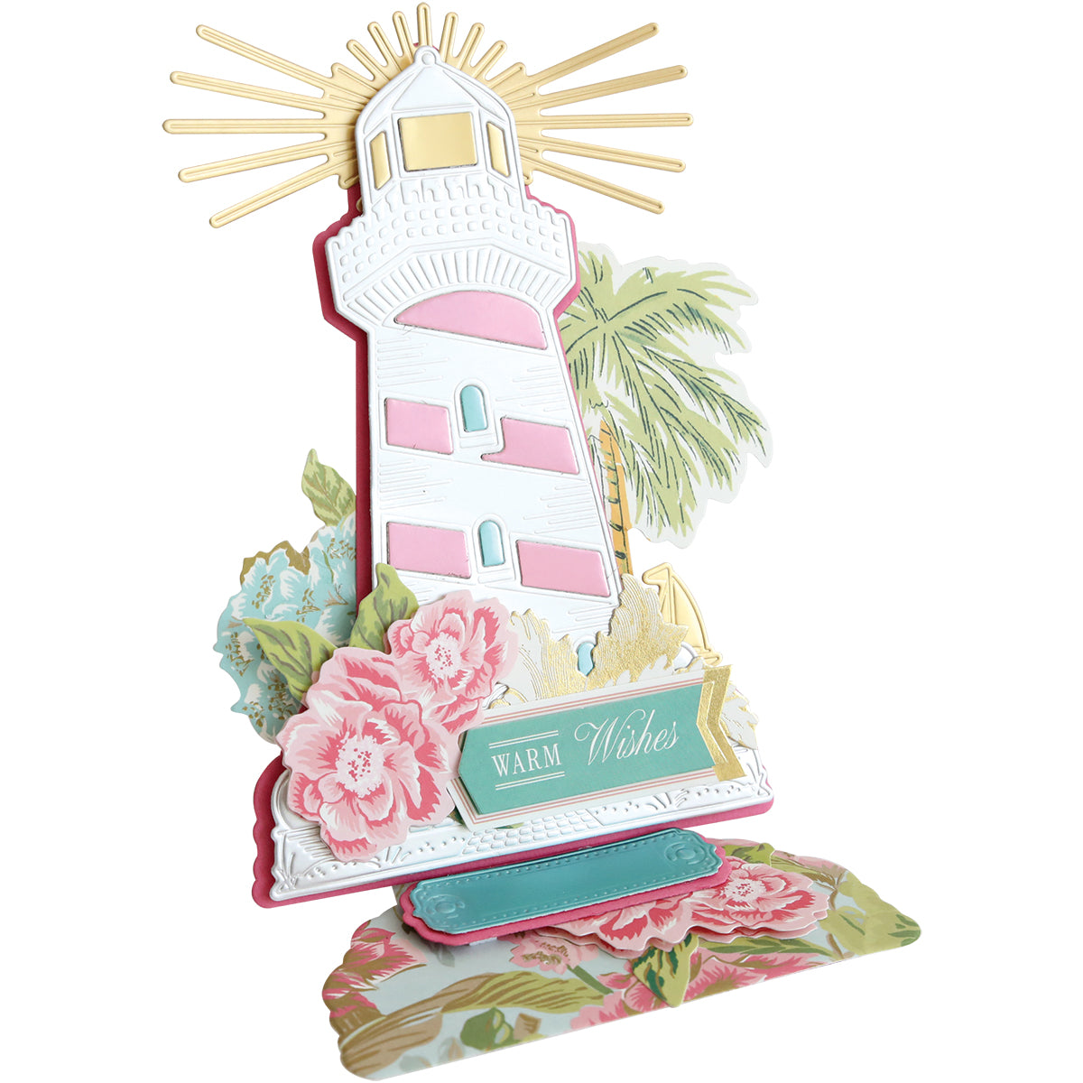 Create an inspirational card using the Lighthouse Easel Die, featuring a pink and white lighthouse, gold sun rays, flowers, and a "Warm Wishes" sign for a decorative touch.
