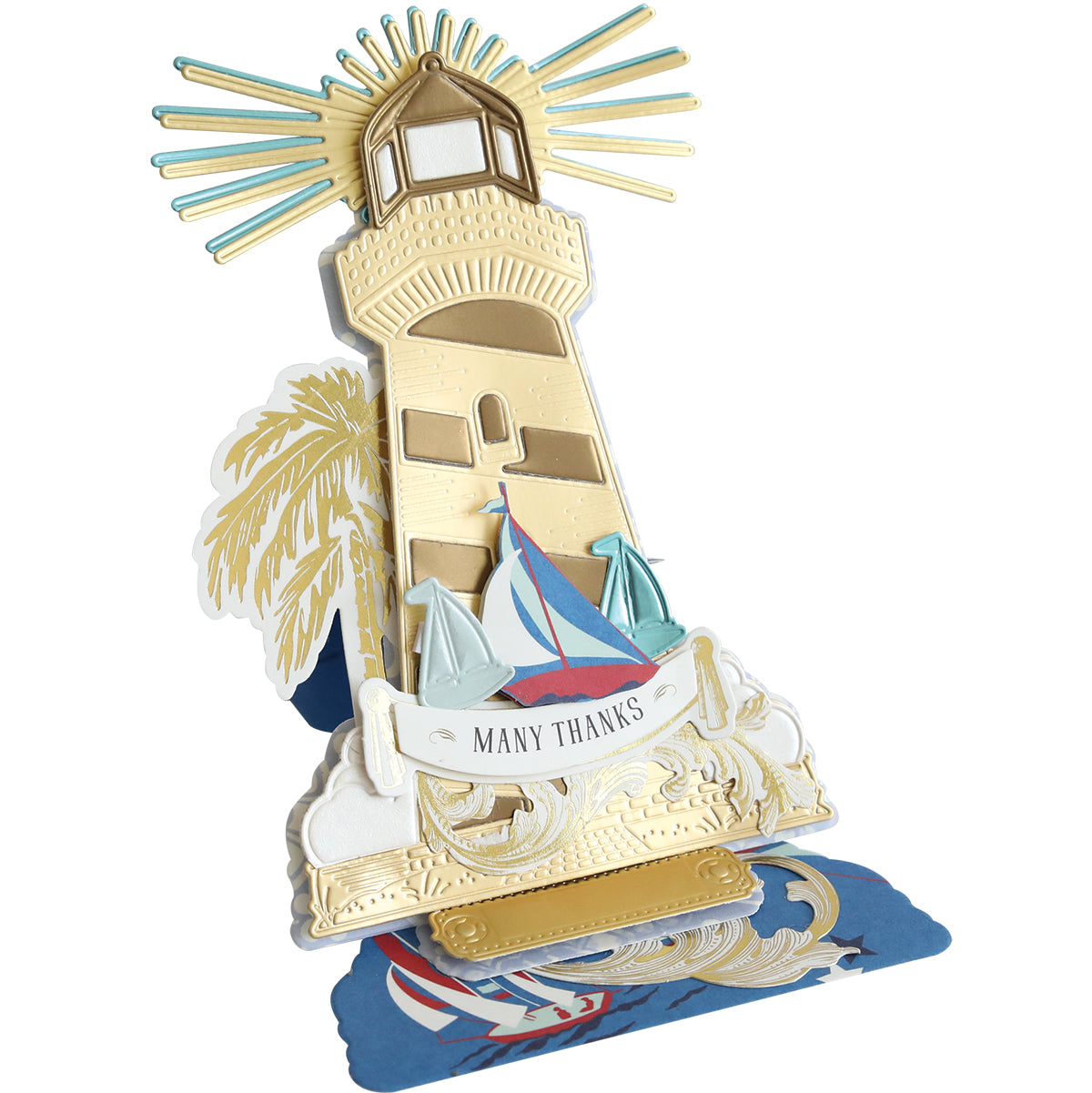 The Lighthouse Easel Die creates a pop-up card with a gold lighthouse, sailboats, palm tree, and "Many Thanks" banner on an ocean-themed base—ideal for fans of inspirational cards and creative crafting projects.