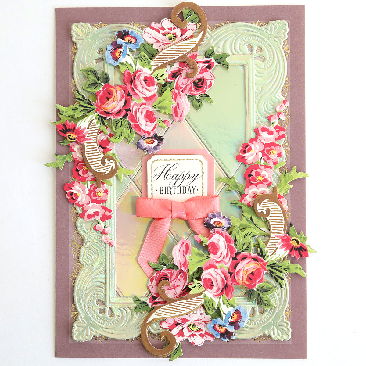 Greeting card crafted from Luxury Iridescent Foil Cardstock, embellished with embossed pink and red floral designs, gold accents, a pink ribbon, and “Happy Birthday” message centered on the front.