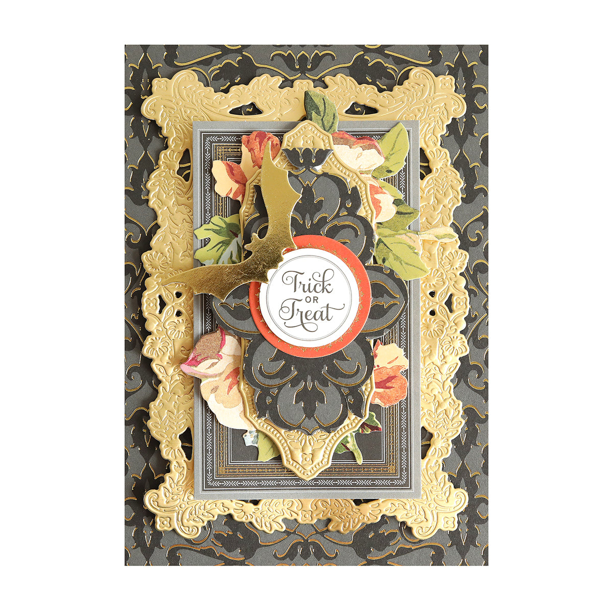 A Halloween card crafted with Luxury Spellbound Foil Cardstock features layered gold and black patterns, a gold bat, floral details, and a central round label that says “Trick or Treat.”.