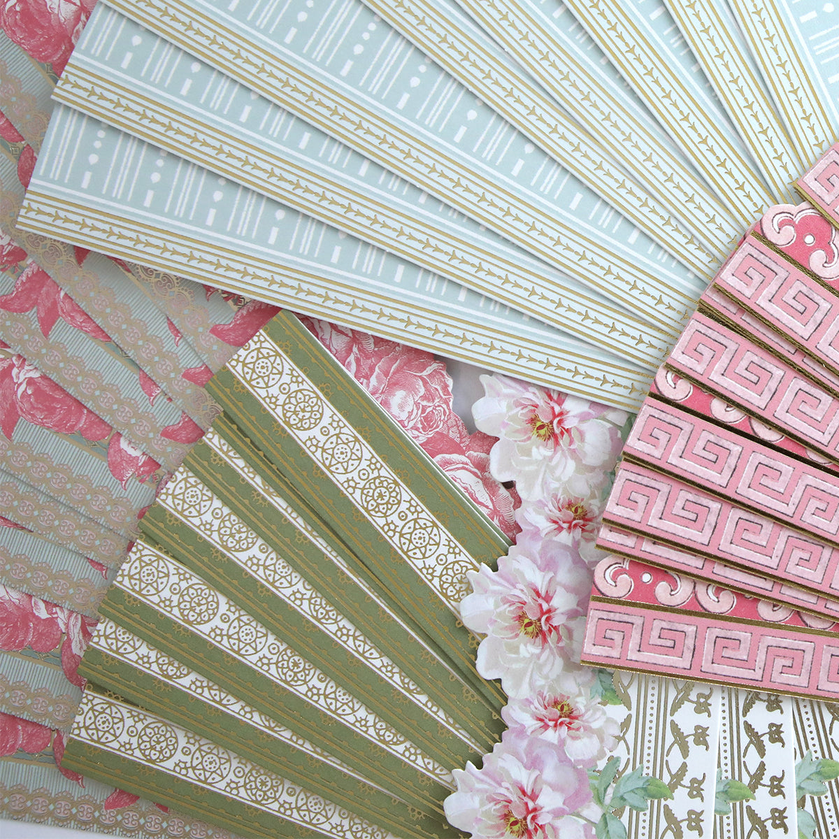 Botanical 12" Border Stickers frame a circular arrangement of decorative paper fans with geometric and floral patterns, accented by pink flowers in the center for a charming display.