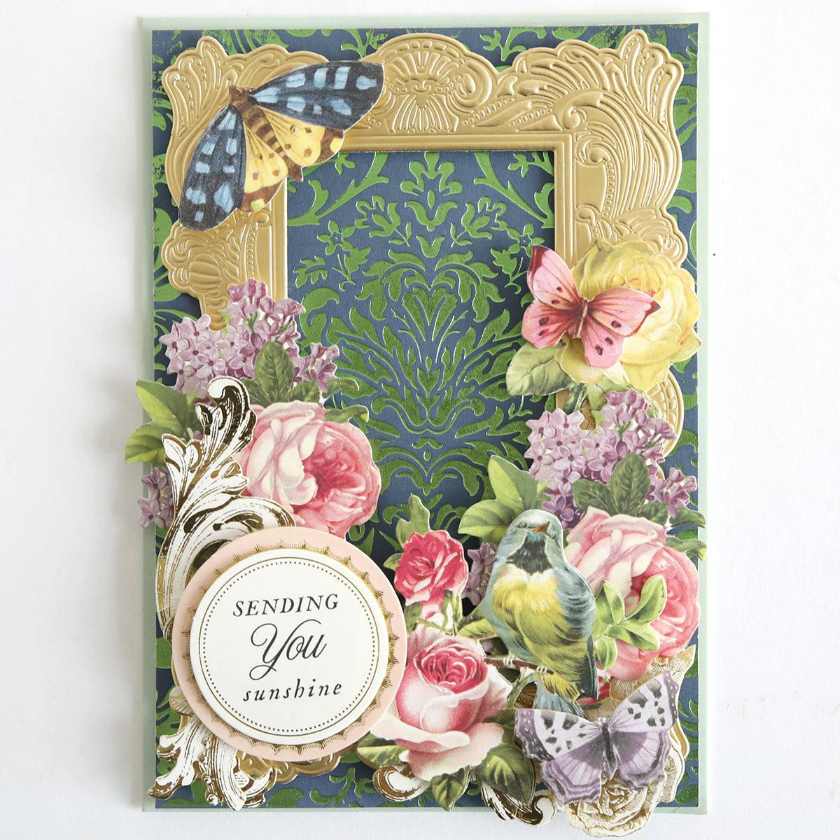 Perfect Palette Antique Gild Hot Foil card features gold foil accents, a green patterned background, colorful butterflies, flowers, a bird, and a “Sending You sunshine” label—ideal for paper craft enthusiasts.