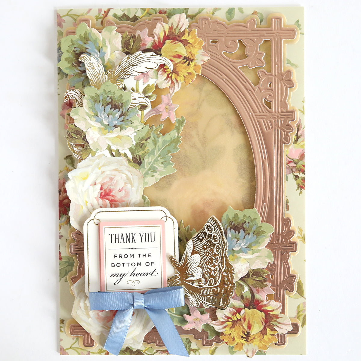 Created with Shimmer Vellum Papers, this greeting card features floral designs, a gold butterfly, ornate frame, and "Thank You From the Bottom of My Heart" sentiment with a blue ribbon bow—ideal for paper crafting projects.